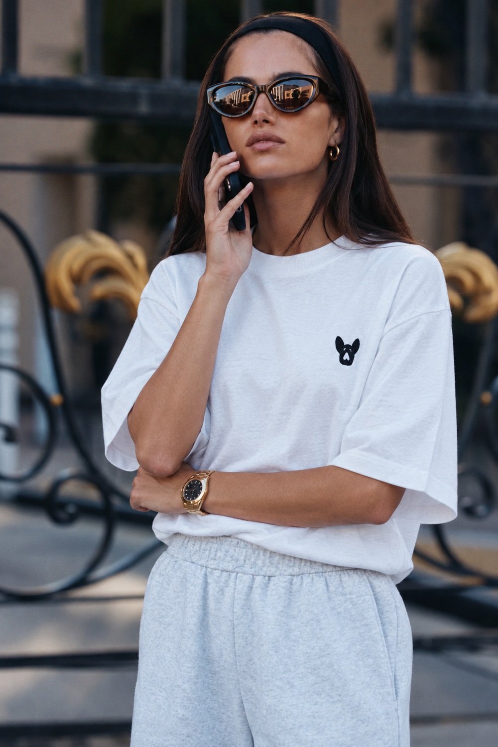 White Frenchie tee with gray sweatpants and a gold watch